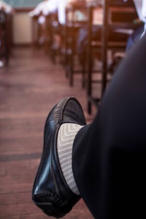 The legs of the teacher controlling the exam in classroomの写真素材
