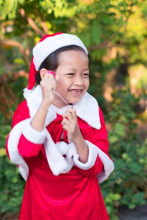 Asian happy child girls in santa claus hats with gift box.Christmas Xmas  conceptの写真素材