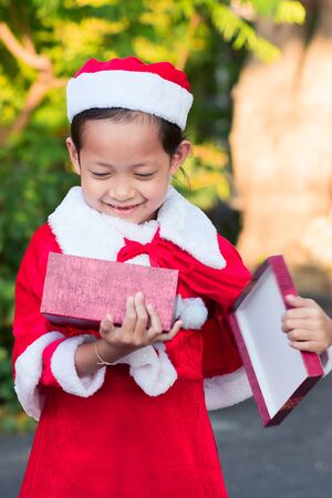 Asian happy child girls in santa claus hats with gift box.Christmas Xmas  conceptの写真素材