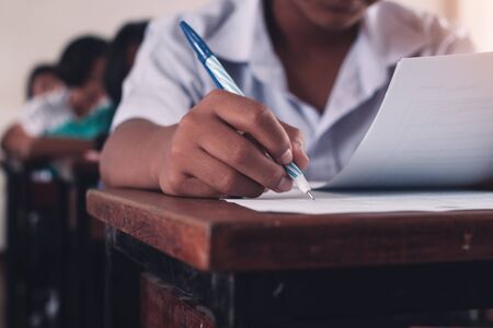 Student taking exam with stress in school classroom