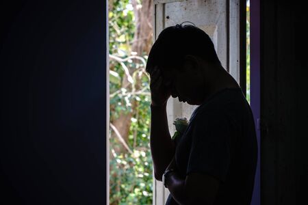 Sad man and rose in valentines day.Low key style.の写真素材
