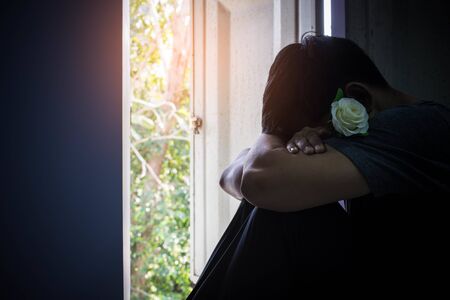 Sad man and rose in valentines day.Low key style.の写真素材