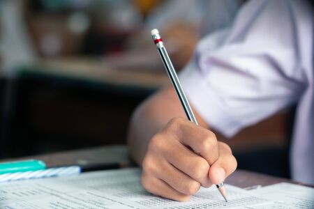Hand of Student doing test or exam  in classroom of school with stressの写真素材