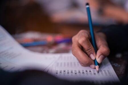 Hand of Student doing test or exam  in classroom of school with stressの写真素材