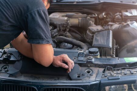 Car mechanic looking and analysis to repairing the engine in the garageの写真素材