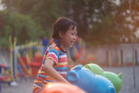 Happy asian little child girl on playgroundの写真素材