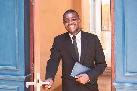 African business man opened the door with smile and be friendlyの写真素材