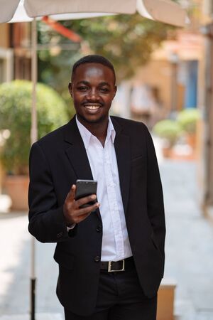 African business man using his smartphone in the cityの写真素材