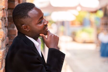 African businessman in suit thinking about business planの写真素材