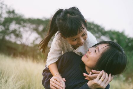 Mother and daughter hugging and lying outdoors with smillig,Concept of I love you momの写真素材