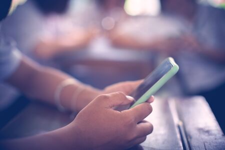 Group of Students Using Smartphones During the Lecture in the classroom.の写真素材