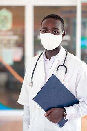 African doctor wear face mask and stethoscope with professional and  kindの写真素材