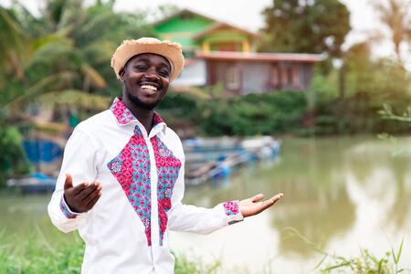 Portrait of african man wearing native cloth traditional colorful with smile and happy.の写真素材