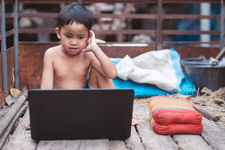 Little boy watching and  studying  online learning  with laptopの写真素材
