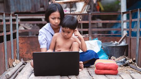 Sister and brother watching and  studying  online learning  with laptop.16:9 styleの写真素材