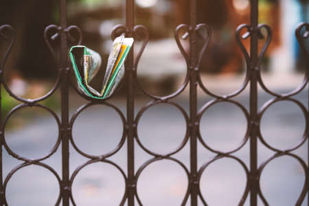 Delivery of a newspaper hang on the fenceの写真素材