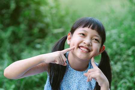 Portrait of a happy smiling asian child girlの写真素材