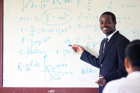 African teacher teaching science in the classroomの写真素材