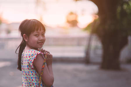 Asian little child girl smiling and looking camera with holding rubberの写真素材