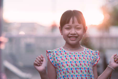 Asian little child girl smiling and looking camera with holding rubberの写真素材