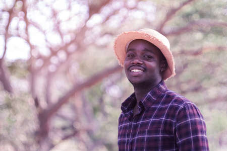Portrait of smiling african man standing on sunny dayの写真素材