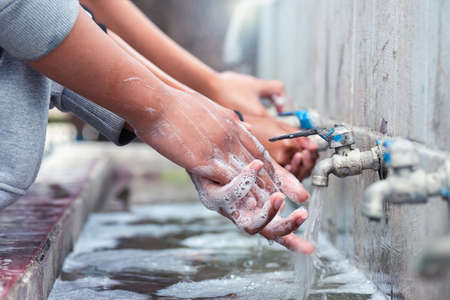 Woman washing  hands with soap for protect Covid-19の写真素材