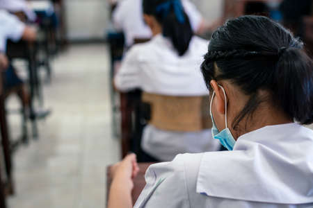 Student doing educational exam test by smartphone with stressの写真素材