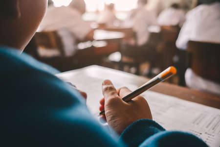 Student reading and taking exam with stressの写真素材