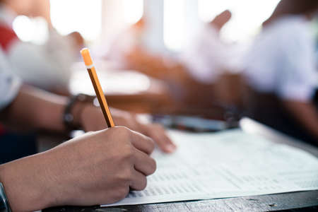 Student reading and taking exam with stressの写真素材