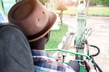 African worker driving heavy construction equipment backhoeの写真素材