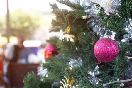 Christmas tree balls at home with a people meeting in backgroundの写真素材