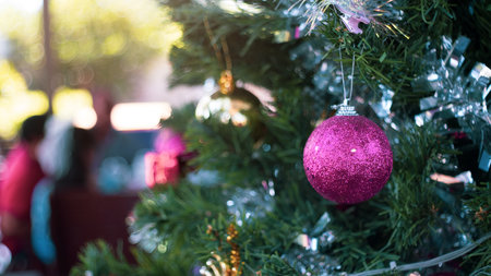 Christmas tree balls at home with a people meeting in backgroundの写真素材