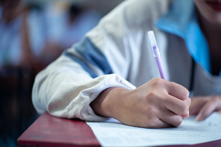 Student reading and taking exam with stressの写真素材