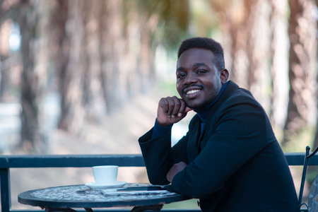 African businessman having a happy time with coffeeの写真素材