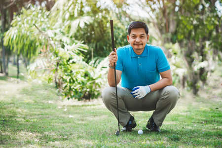 Golf player looking and sitting on field for playing golf on course teeの写真素材