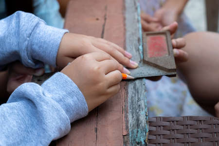 The childens is repairing wooden with a pencil and sceneの写真素材