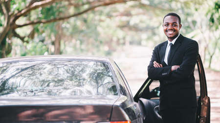 African Business man in suit standing with car.16:9 styleの写真素材