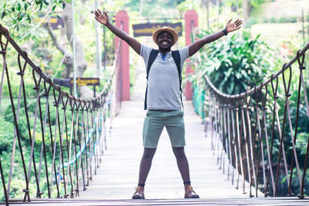 African man traveler standing on the bridge with smile and happyの写真素材