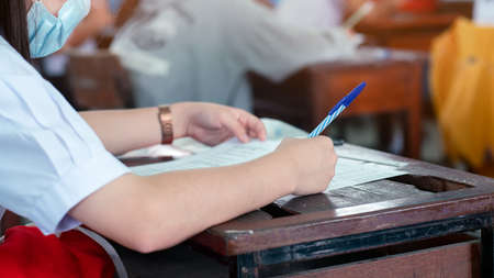 Students wearing face mask for protect  and doing exam in classroom with stress.16:9 styleの写真素材