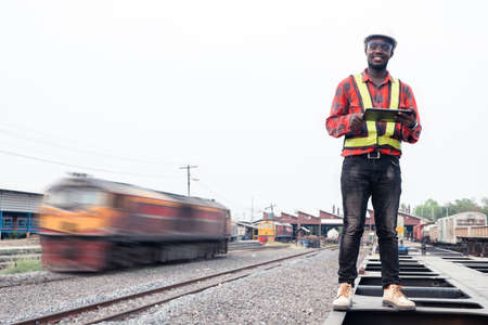 African engineer   control a the train on railway with using tabletの写真素材