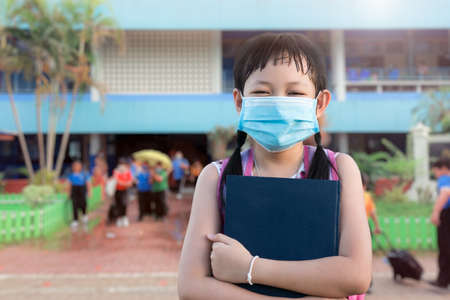 Little girl student wearing face mask for protect covid-19 in school