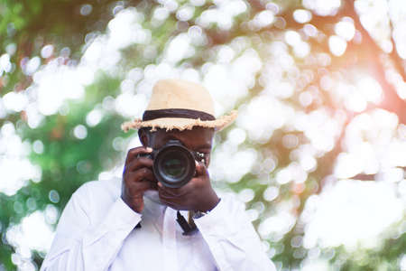 African man photographer takes pictures with the digital cameraの写真素材