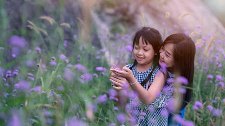 Happy mother and daughter smiling in a beautiful lavender field.Concept of mother day