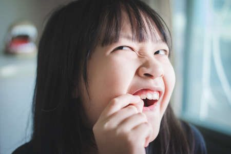 Asian little child  girl have toothacheの写真素材