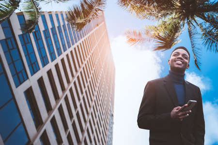 African business man in a suit at a luxurious tropical beachfront hotelの写真素材