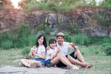Family picnicking in the midst of nature with the cliff of backgroundの写真素材