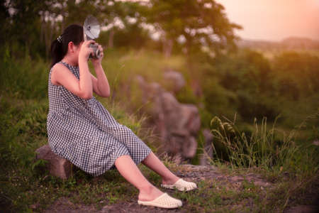 Vintage little girl of  photographers are happily taking pictures with the film cameraの写真素材