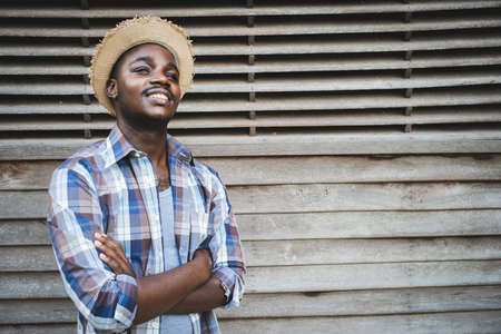 Portrait of african farmer man standing with crossing arms and smilingの写真素材