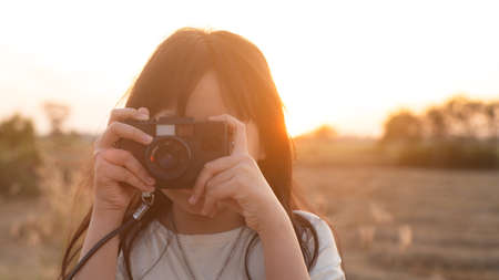 Young girl practicing photography in beautiful natural light