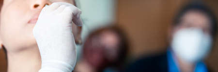 The man swab COVID-19 testing by ATK or Rapid Antigen Test kit  with a cotton nasal swabの写真素材